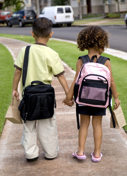 Two Young Children Walking to School